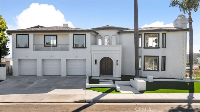 view of front of property featuring a garage and a balcony