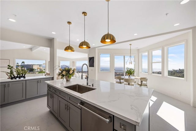 kitchen with decorative light fixtures, dishwasher, sink, a kitchen island with sink, and light stone countertops