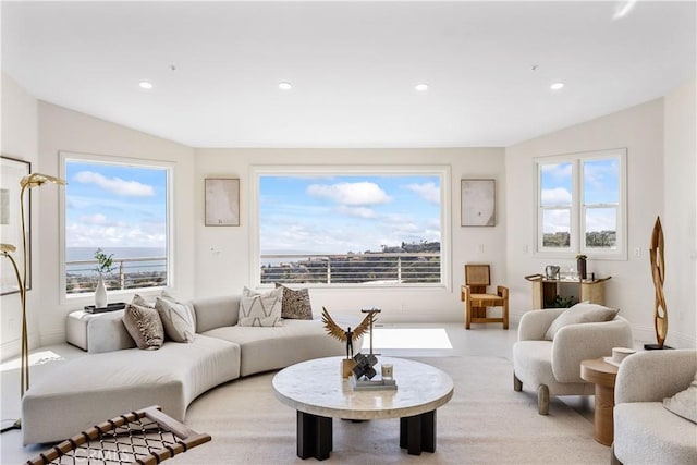 living room featuring vaulted ceiling and a water view