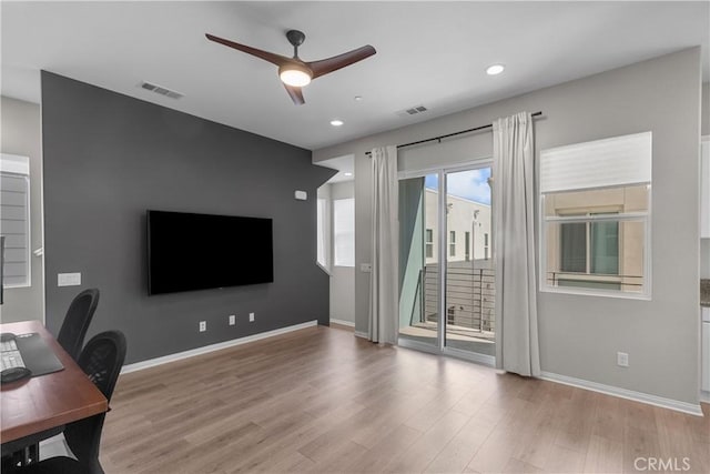 office space with ceiling fan and light hardwood / wood-style floors