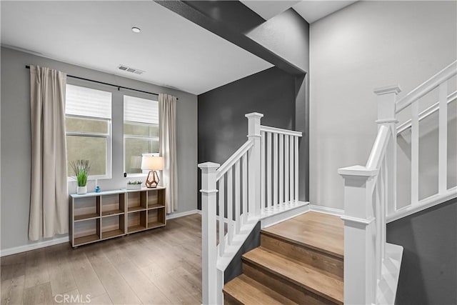 stairs with hardwood / wood-style flooring