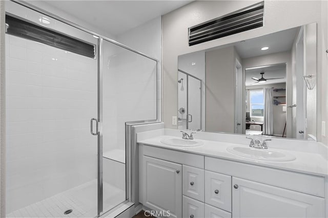 bathroom with ceiling fan, vanity, and a shower with shower door