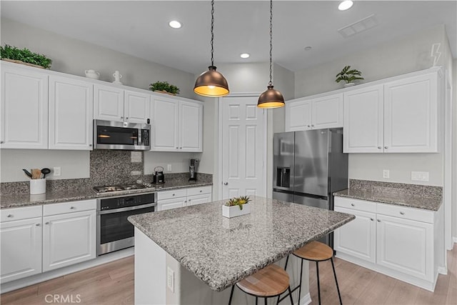 kitchen with white cabinetry and appliances with stainless steel finishes