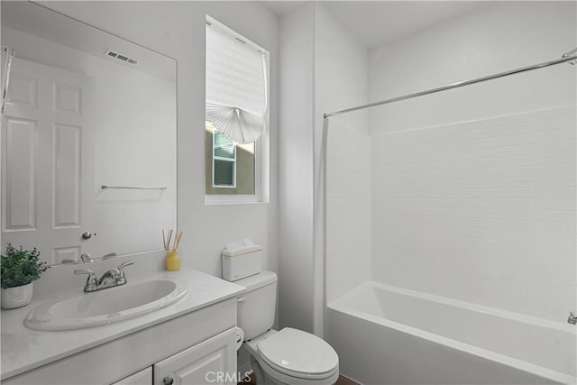 full bathroom featuring vanity, bathtub / shower combination, and toilet