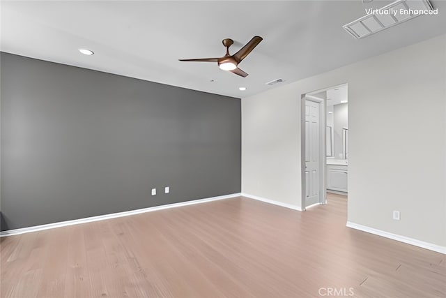 empty room featuring light hardwood / wood-style flooring and ceiling fan