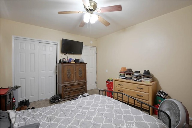 bedroom featuring ceiling fan, a closet, and carpet floors