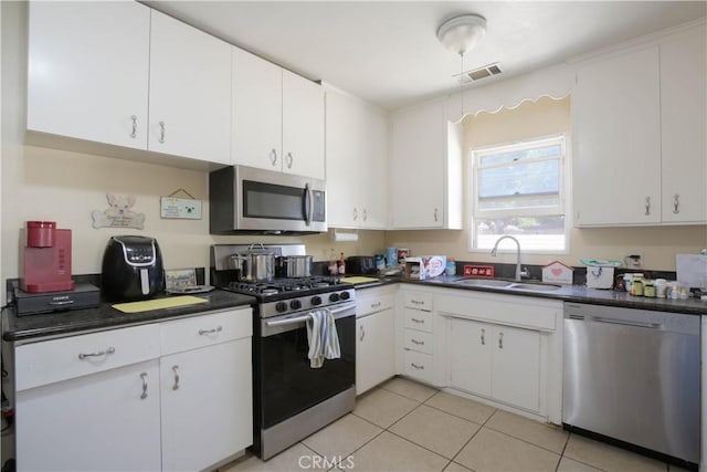 kitchen with sink, white cabinets, and appliances with stainless steel finishes