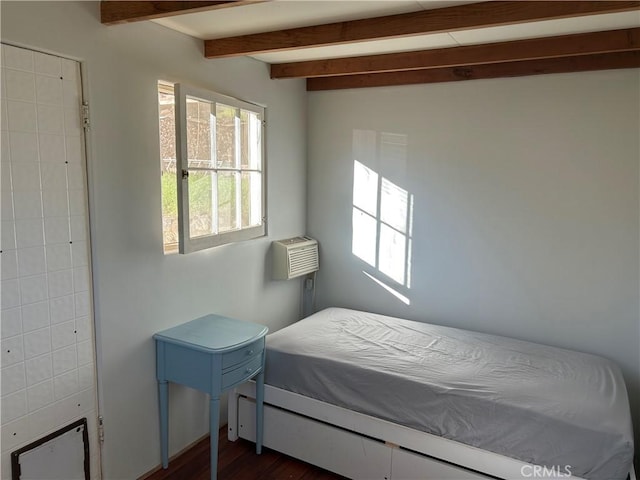 bedroom with dark hardwood / wood-style flooring, lofted ceiling with beams, and a wall mounted air conditioner