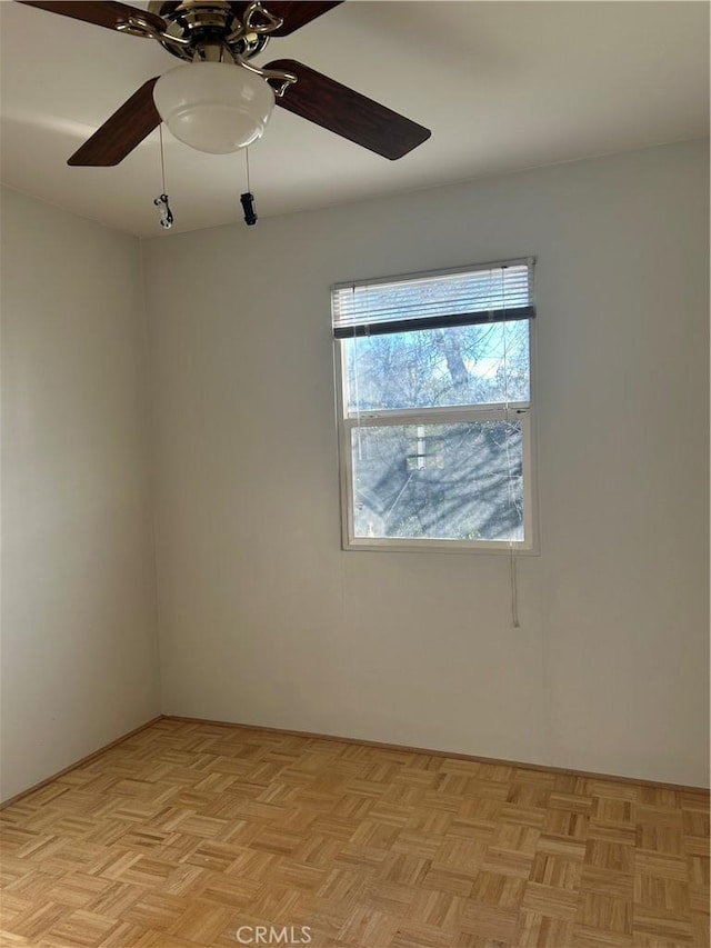 unfurnished room featuring ceiling fan and light parquet flooring