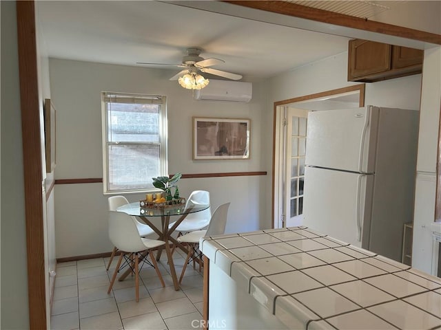 unfurnished dining area with ceiling fan, light tile patterned floors, and a wall mounted air conditioner