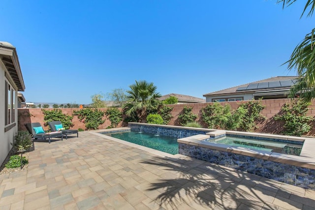 view of swimming pool with an in ground hot tub and a patio area