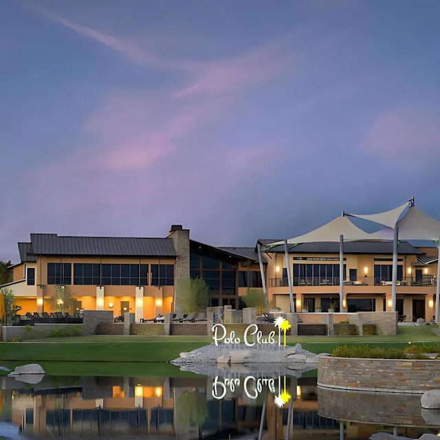 view of back house at dusk