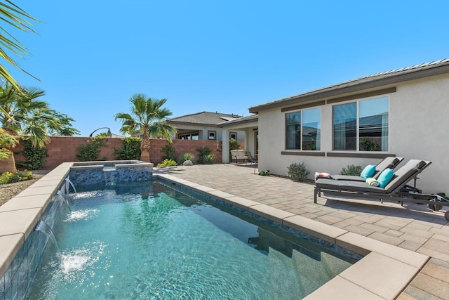 view of swimming pool with pool water feature, a patio, and an in ground hot tub