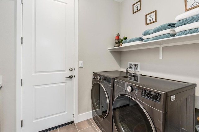 laundry area featuring separate washer and dryer and light tile patterned floors