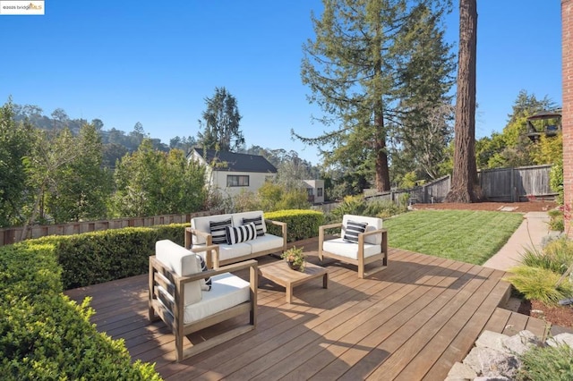 wooden deck featuring an outdoor hangout area and a lawn