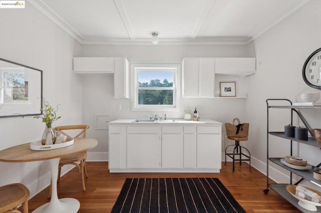 kitchen featuring sink, white cabinetry, light hardwood / wood-style floors, and crown molding