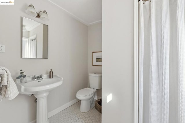 bathroom featuring toilet and tile patterned floors