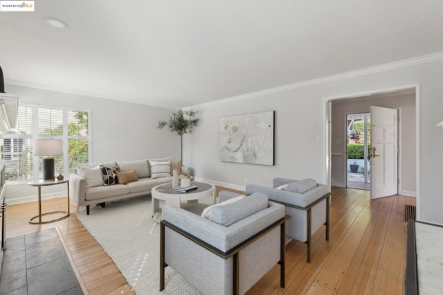 living room featuring ornamental molding and hardwood / wood-style flooring