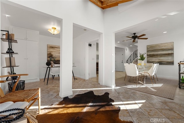 interior space featuring light tile patterned flooring and ceiling fan