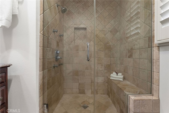 bathroom featuring vanity and a shower with door