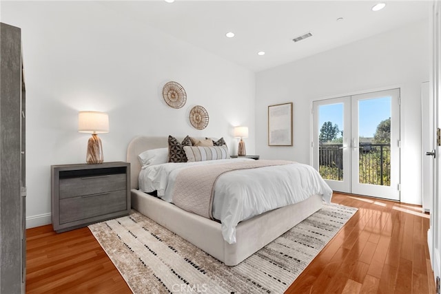 bedroom featuring french doors, wood-type flooring, and access to exterior