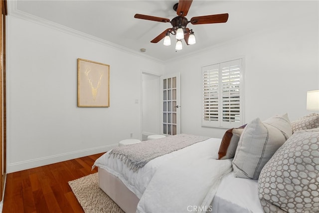 bedroom with dark wood-type flooring, ceiling fan, and ornamental molding