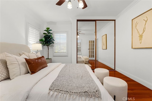 bedroom with ceiling fan, wood-type flooring, and ornamental molding