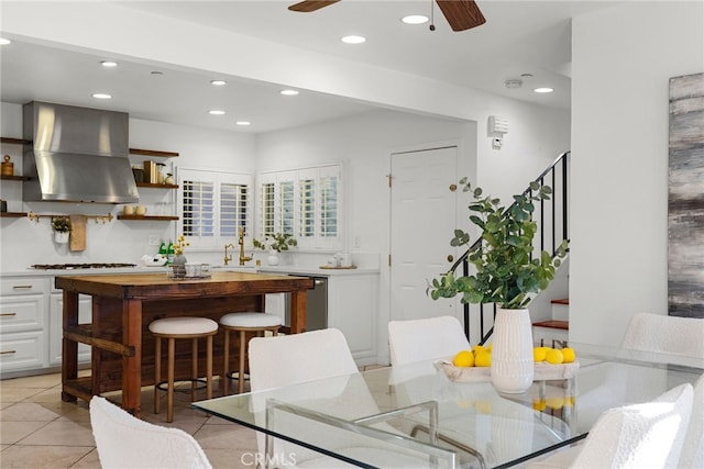 tiled dining space with ceiling fan