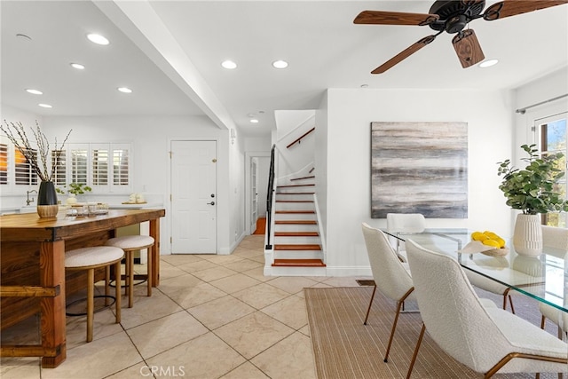 tiled dining space with ceiling fan