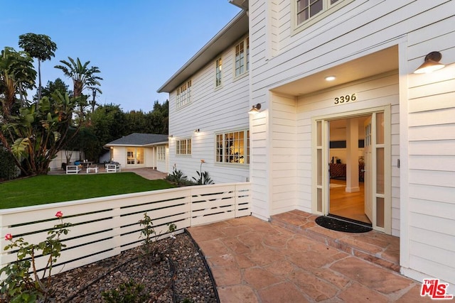 entrance to property featuring a yard