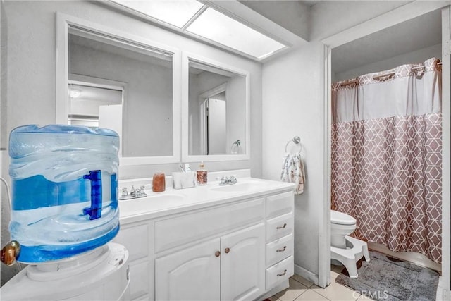 bathroom with curtained shower, toilet, vanity, and tile patterned flooring