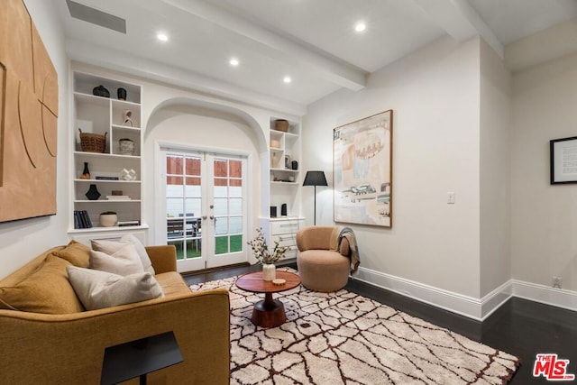 living area featuring french doors, dark wood-type flooring, and beamed ceiling