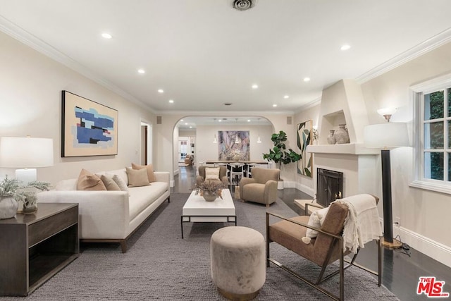 living room featuring built in features and crown molding