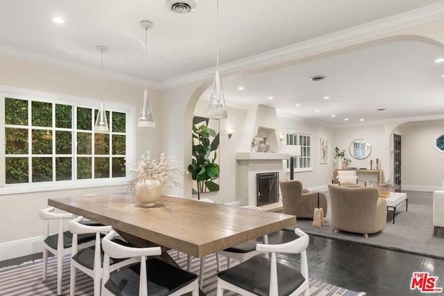 dining area with crown molding and hardwood / wood-style floors