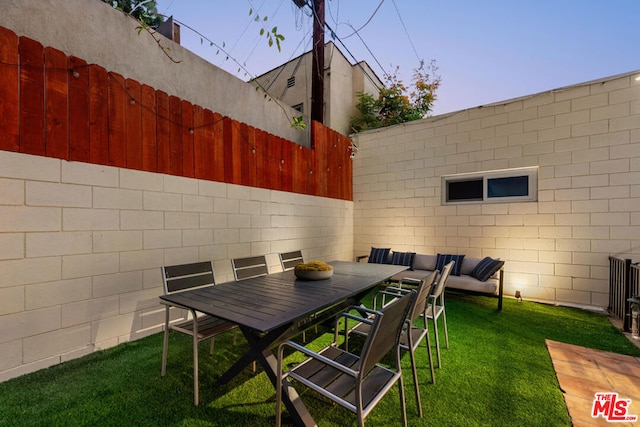 patio terrace at dusk with a yard