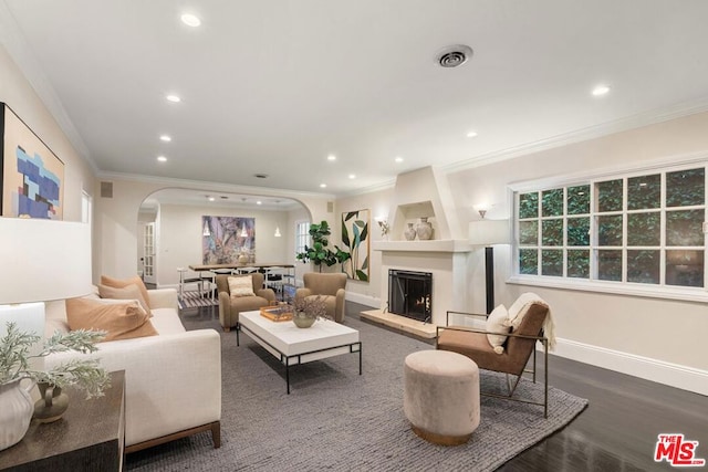 living room featuring hardwood / wood-style flooring, built in shelves, and ornamental molding