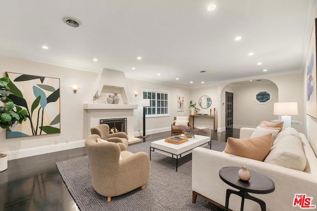 living room featuring dark hardwood / wood-style flooring and ornamental molding