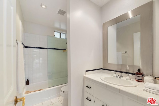 full bathroom with toilet, combined bath / shower with glass door, tile patterned floors, and vanity