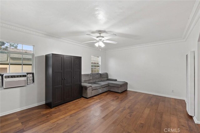 unfurnished living room with ceiling fan, dark wood-type flooring, a wealth of natural light, and crown molding