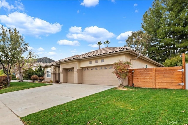 view of front of home featuring a front lawn and a garage