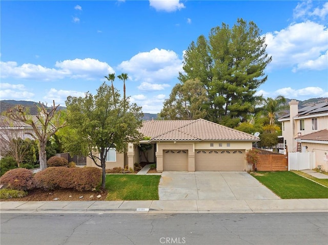 view of front of property with a front yard and a garage