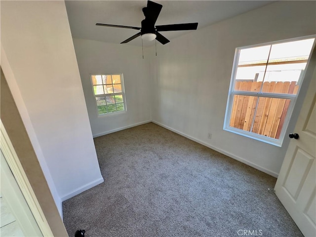 spare room featuring ceiling fan and carpet floors