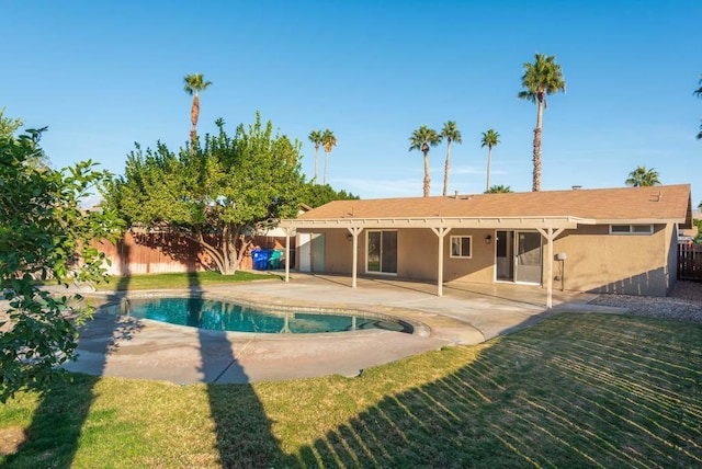 view of swimming pool with a lawn and a patio