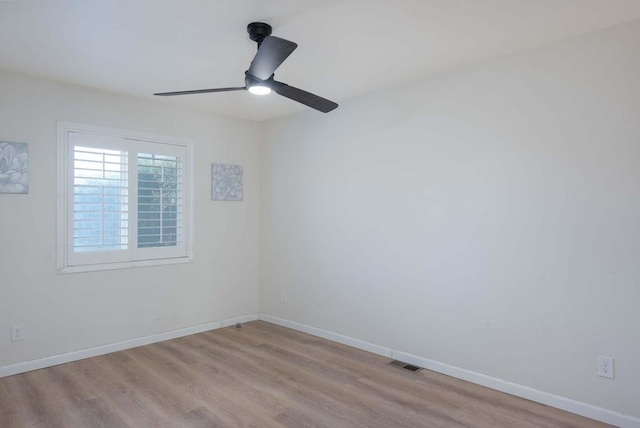 spare room featuring ceiling fan and light wood-type flooring