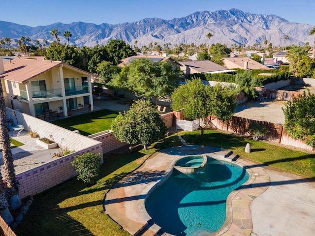 view of pool featuring a mountain view, an in ground hot tub, a yard, and a patio