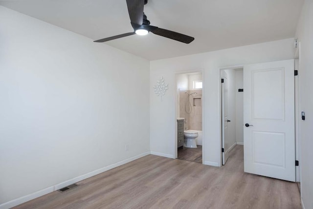 unfurnished bedroom featuring ceiling fan, light hardwood / wood-style flooring, and ensuite bath