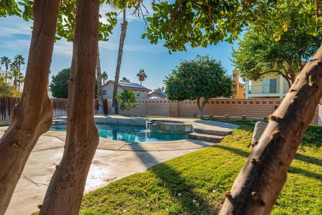 view of swimming pool featuring a patio and an in ground hot tub