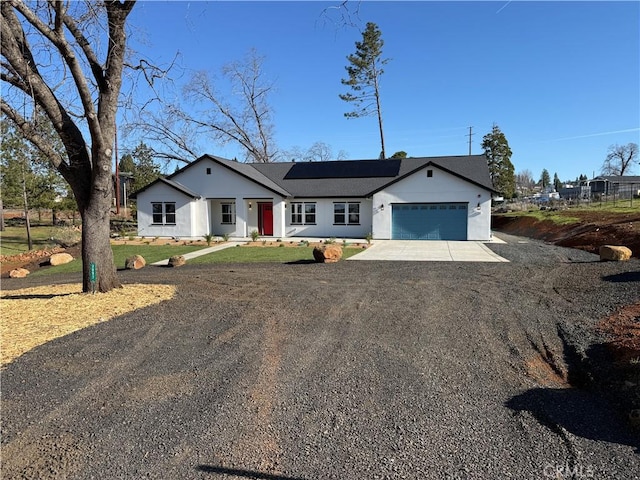 single story home with driveway and an attached garage