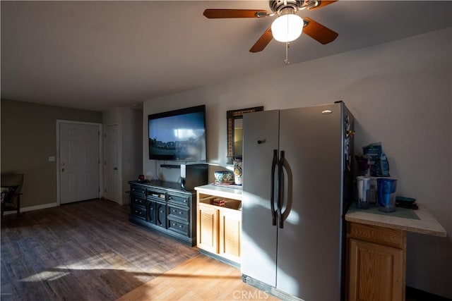 kitchen with ceiling fan, stainless steel fridge, and light hardwood / wood-style floors