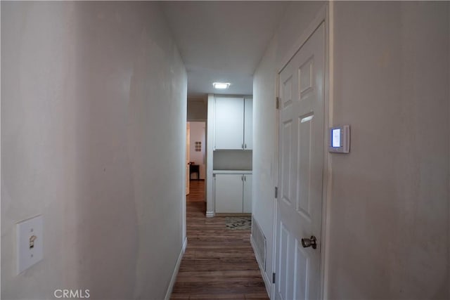 hall with dark hardwood / wood-style flooring